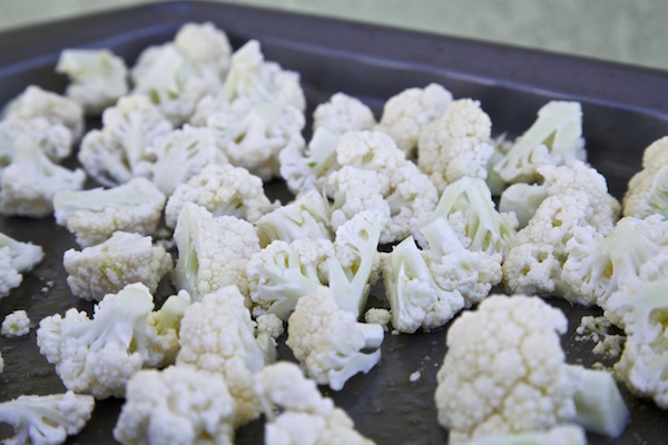 pieces of cauliflower on a baking sheet
