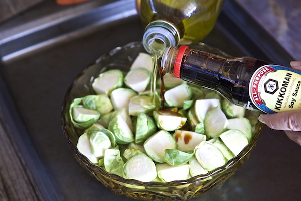 coating brussels sprouts with olive oil and #kikkomansabor