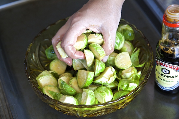 mixing brussels sprouts with hand