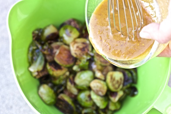 pour dressing over brussels sprouts