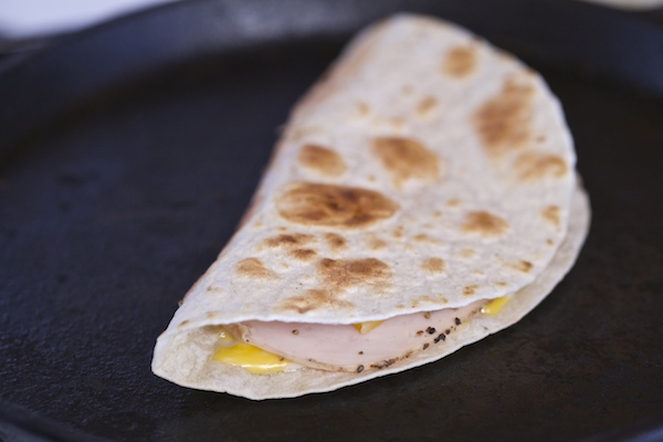Folded quesadilla stuffed with cheese and turkey