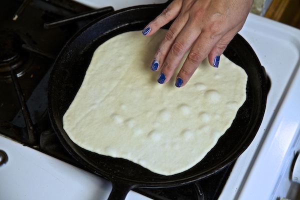 flour tortilla cooking on the comal