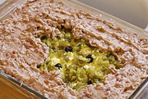 refried beans spread over chiles