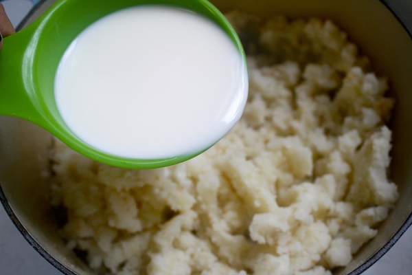 add in milk to mashed potatoes