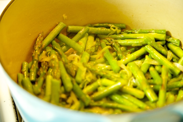 asparagus and leeks saute in a pot to make soup. 