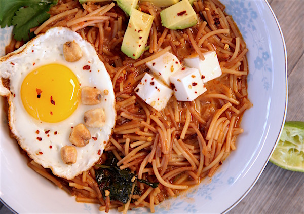 This fideo is made with Barilla's cut spaghetti and cooked in a spicy broth. Garnish with panela cheese, avocado, fried egg, corn nuts, cilantro and fresh lime juice. Spicy fideo fully loaded you'll never want it any other way. 