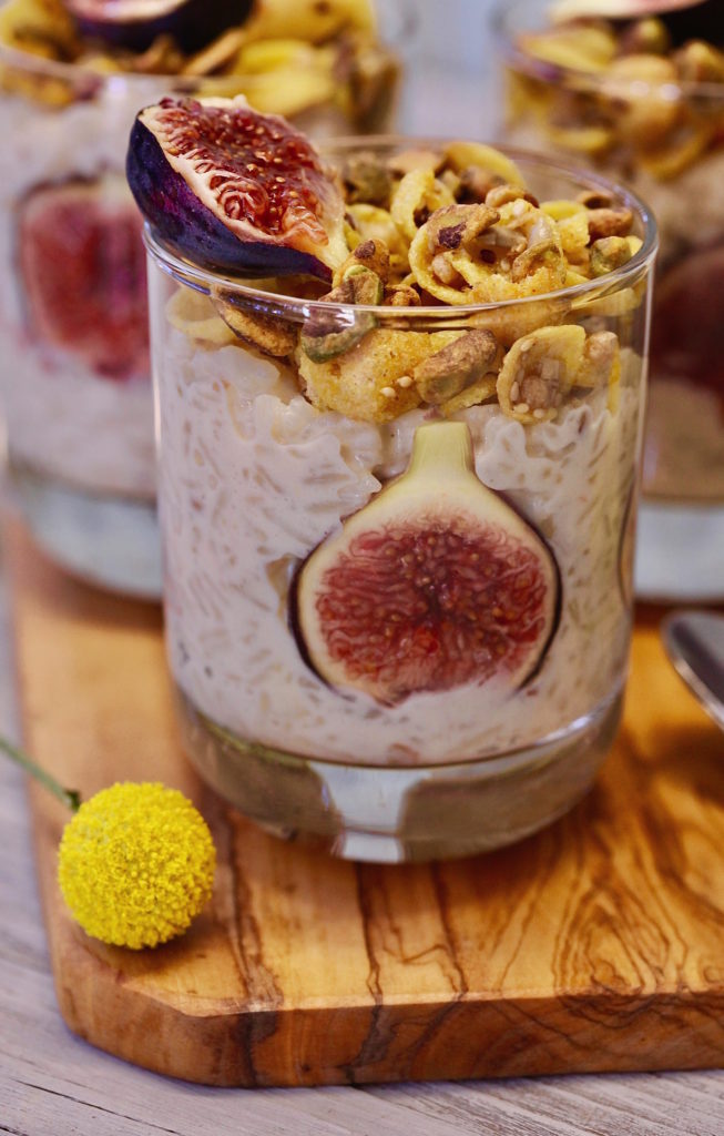 Pistachio Fig Arroz con Leche garnished with figs and gluten free granola. 